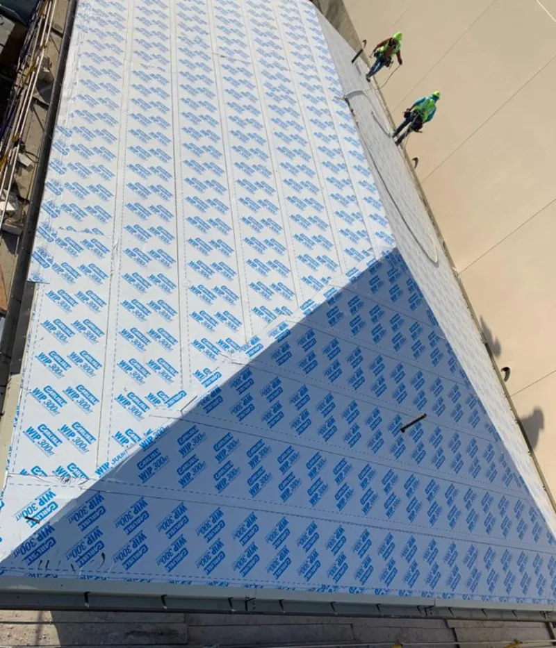 Professional roofers installing underlayment on a metal roof in Little Falls